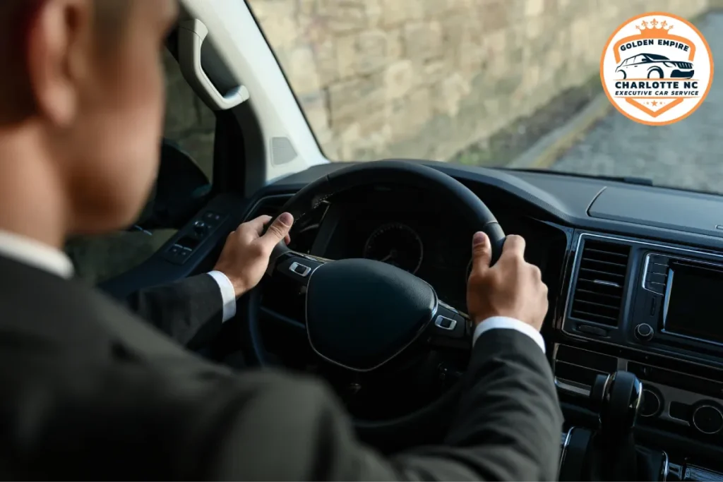 Close-up of a chauffeur's hands gripping the steering wheel while driving