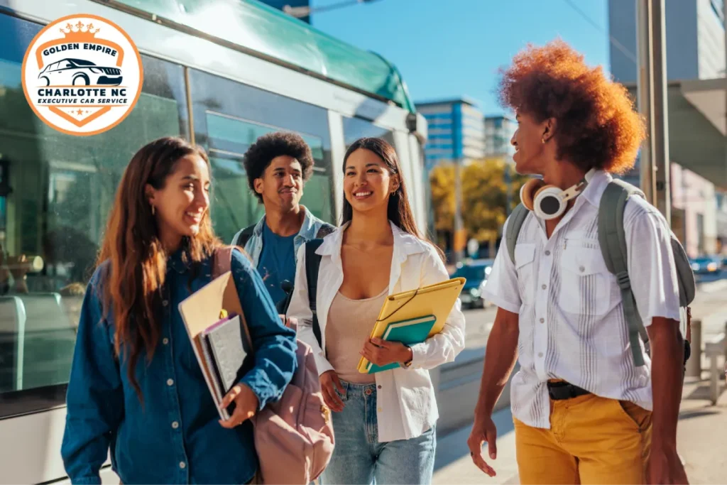 College students walking together near a tram station, smiling.