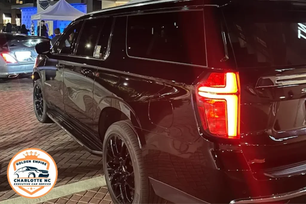 Luxury black SUV executive transportation service at night