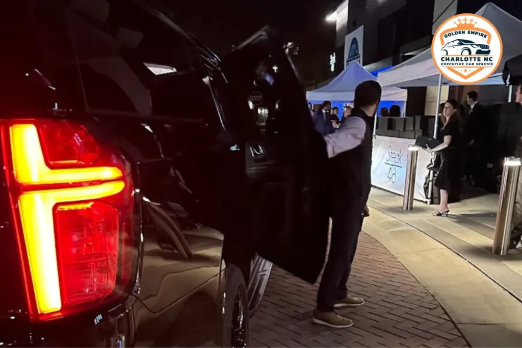 Chauffeur opening a luxury SUV for concert transportation.