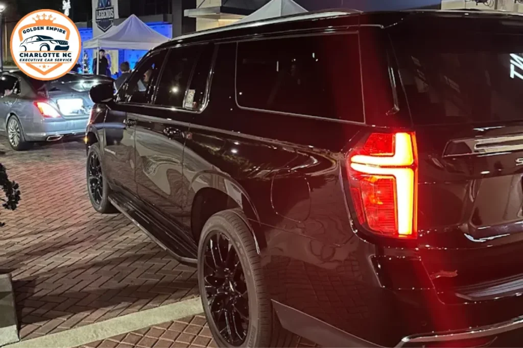 Black luxury SUV ready for concert transportation at night.